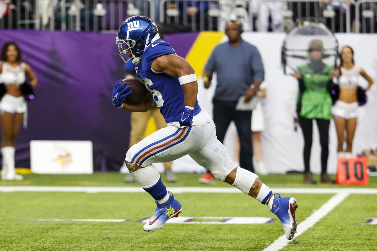 Saquon Barkley #26 of the New York Giants runs with the ball for a touchdown against the Minnesota Vikings in the fourth quarter of the game at U.S. Bank Stadium on December 24, 2022 in Minneapolis, Minnesota. The Vikings defeated the Giants 27-24.