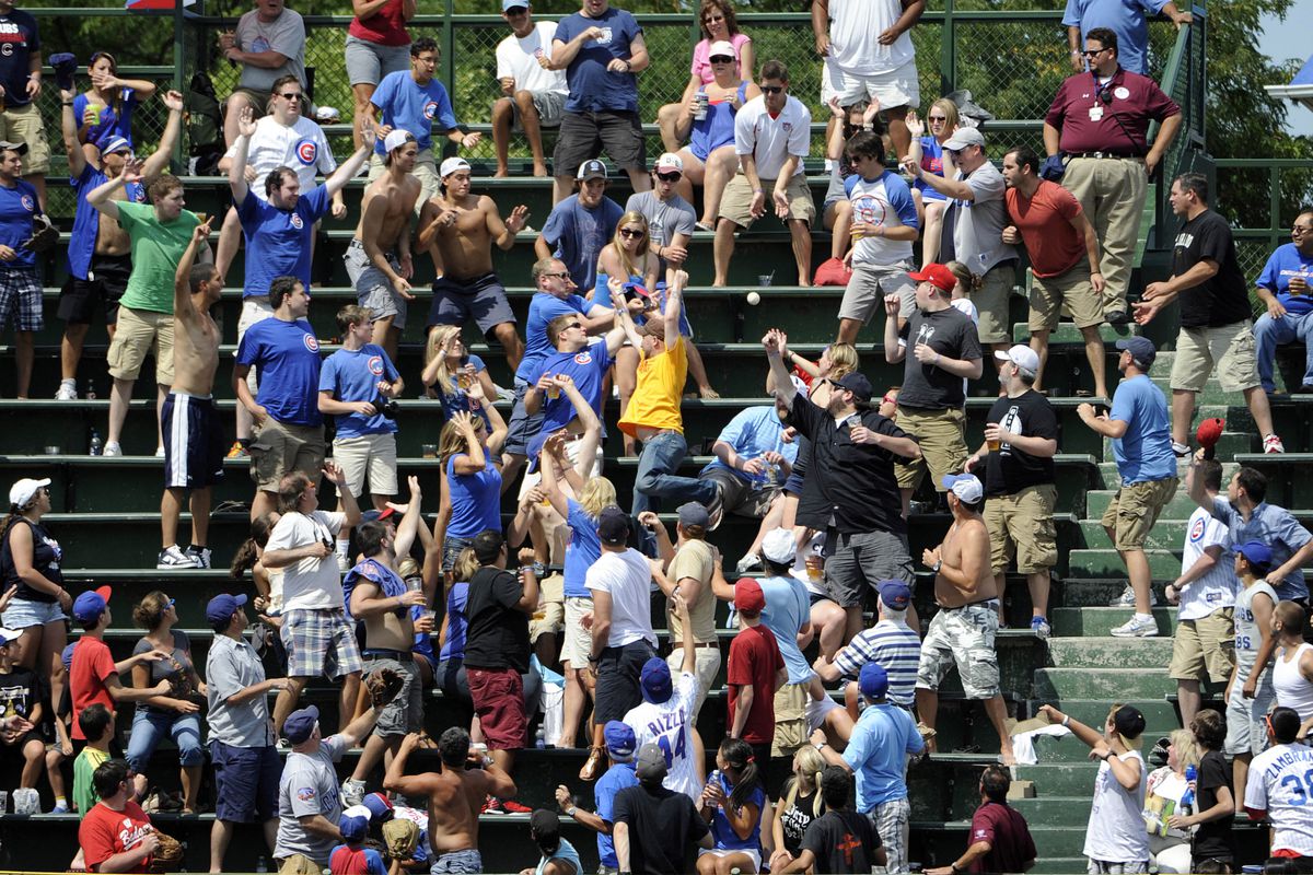 Chicago, IL, USA; Fans in the bleachers catch a two run home run off the bat of Chicago Cubs shortstop Starlin Castro against the Houston Astros at Wrigley Field. Credit: David Banks-US PRESSWIRE
