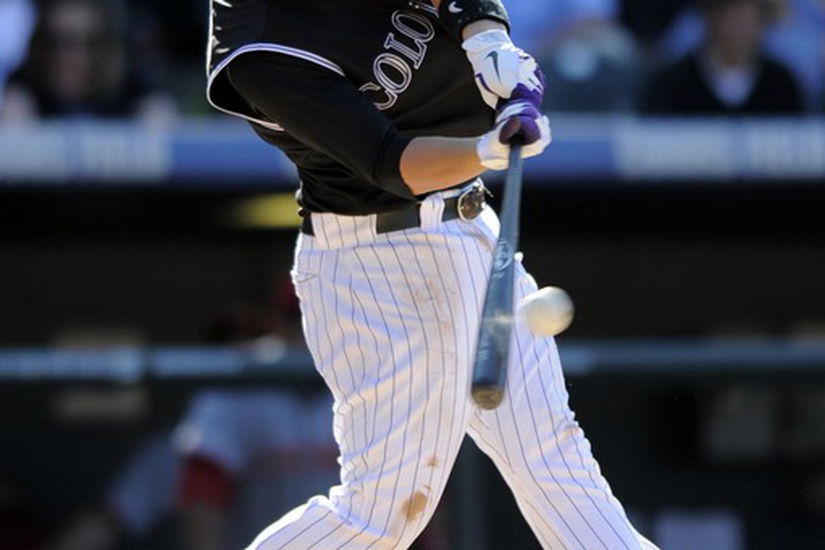 DENVER, CO - SEPTEMBER 10: Jordan Pacheco #58 of the Colorado Rockies hits a home run against the Cincinnati Reds at Coors Field on September 10, 2011 in Denver, Colorado. Colorado beat Cincinnati 12-7.  (Photo by Jack Dempsey/Getty Images)