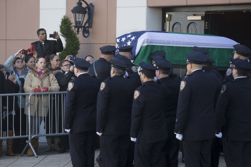 <small><strong>The casket of New York Police Department officer Rafael Ramos arrives to his wake at Christ Tabernacle Church in the Glendale section of Queens, where he was member, Friday, Dec. 26, 2014, in New York. | John Minchillo / AP</strong></small>