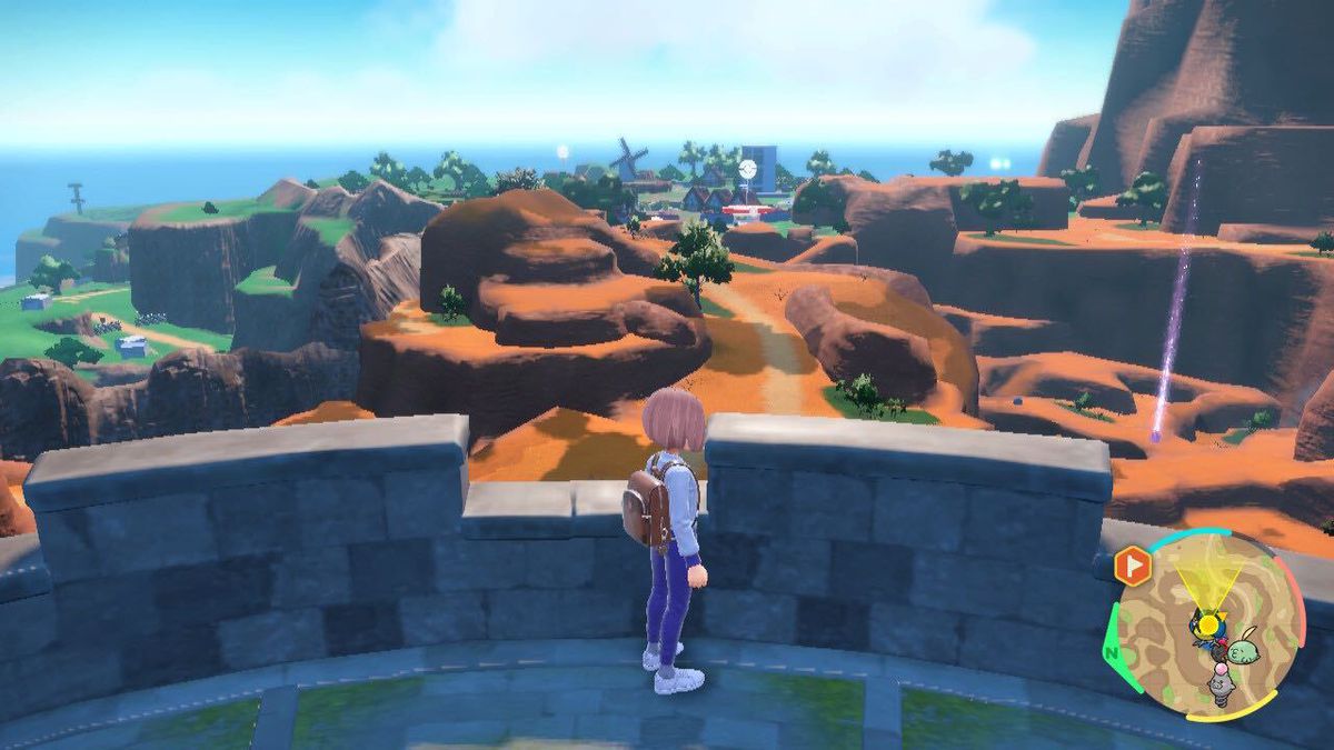 Standing atop a watchtower in Pokémon Scarlet and Violet, overlooking a desert landscape that leads toward a PokéStop.