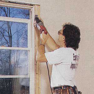 <p><b>1.</b> SLIP the blade of the reciprocating saw between the side jamb of the window and trimmer stud to slice through any nails.</p>