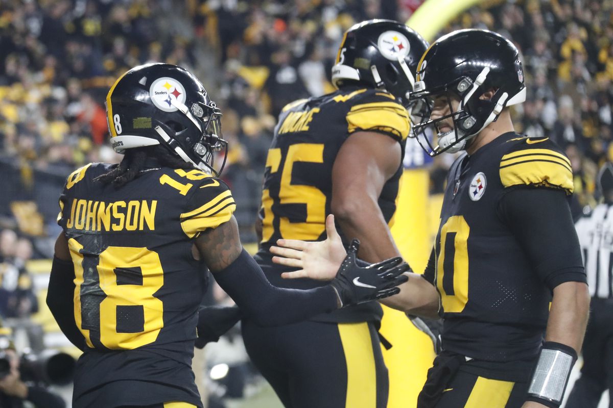 Pittsburgh Steelers wide receiver Diontae Johnson (18) and quarterback Mitch Trubisky (10) celebrate after combining for a touchdown against the New England Patriots during the second quarter at Acrisure Stadium. New England won 21-18.
