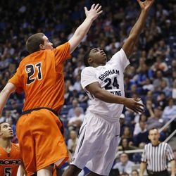 Brigham Young Cougars guard Frank Bartley IV (24) lays i the ball by Pacific Tigers forward Jacob Lampkin (21) at the Marriott Center Saturday, Feb. 14, 2015. BYU beat the Tigers, 84-59.