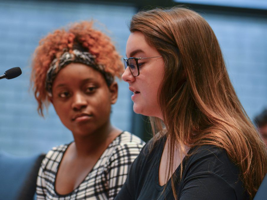 Tamara Reed (left), a Chicago Public Schools student, and Morgan Aranda, a former student, testify during a hearing before the state Senate Education and House Elementary and Secondary Education Joint Committee about allegations of sexual misconduct in th