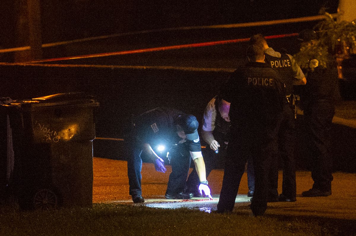 Chicago police investigate a man shot and killed on a bike path Monday night at Loyola Park in Rogers Park. The man was later identified as Eliyahu Moscowitz, 24. | Tyler LaRiviere/Sun-Times