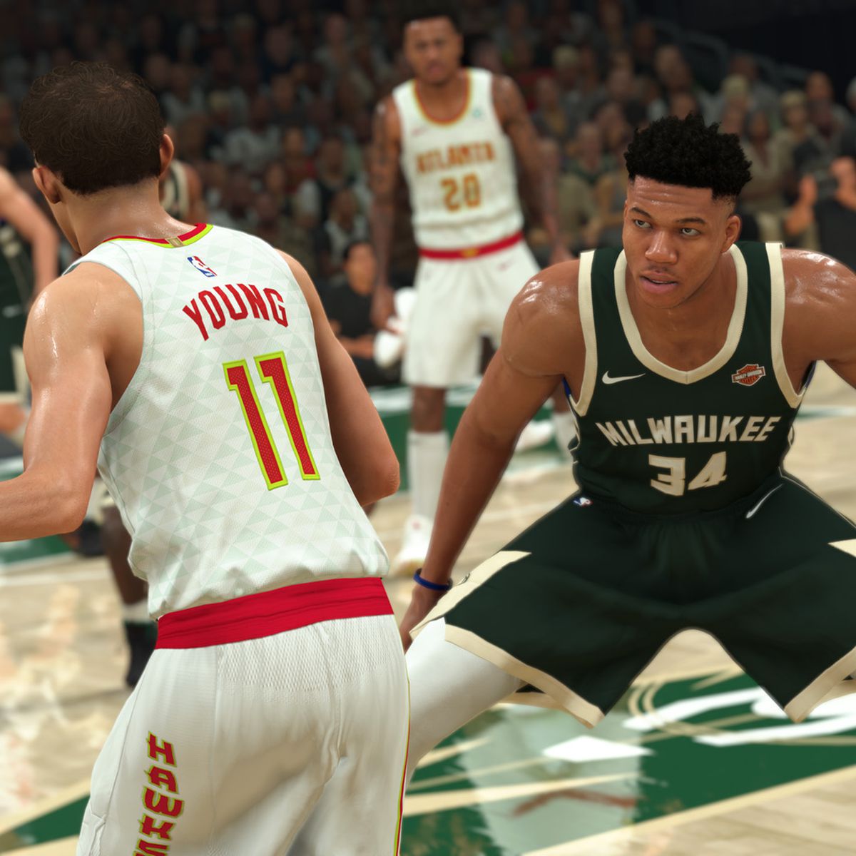 Trae Young sizes up defender Giannis Antetokounmpo at midcourt in NBA 2K21