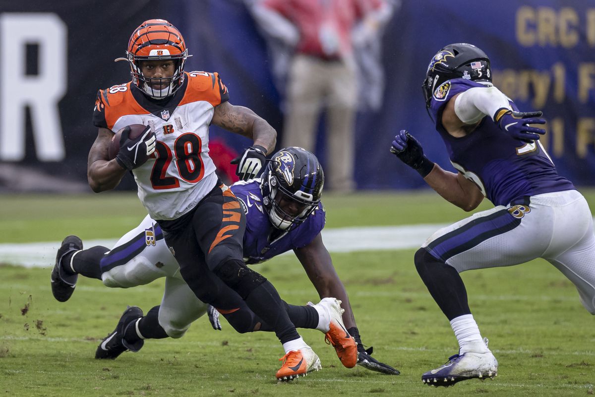 Joe Mixon #28 of the Cincinnati Bengals carries the ball as Jaylon Ferguson #45 and L.J. Fort #58 of the Baltimore Ravens defend during the second half at M&amp;T Bank Stadium on October 11, 2020 in Baltimore, Maryland.
