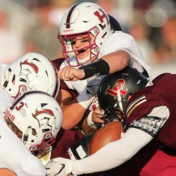 Herriman's Jaxon James is sacked as the Mustangs and Lone Peak open the 2018-19 football season at Lone Peak on Friday, Aug. 17, 2018. The game is delayed at the half for weather.