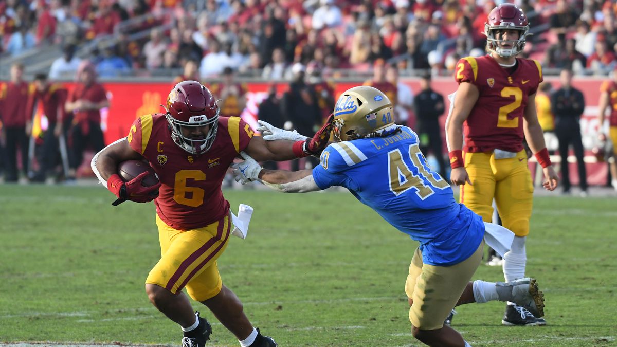 Southern California Trojans running back Vavae Malepeai (6) runs the ball against UCLA Bruins linebacker Caleb Johnson (40) in the second half at the Los Angeles Memorial Coliseum.