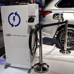 <em>Mitsubishi’s bi-directional charger, shown here plugged into a Mitsubishi Outlander, was on display at the Geneva Motor Show</em>