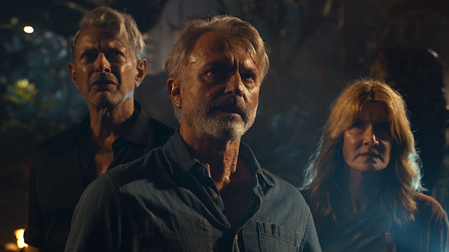 Jeff Goldblum, Sam Neill, and Laura Dern stand together in Jurassic World: Dominion