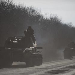 Ukrainian troops ride ride on a self-propelled artillery near Artemivsk, eastern Ukraine, Monday, Feb. 23, 2015. A Ukrainian military spokesman says continuing attacks from rebels are delaying Ukrainian forces' pullback of heavy weapons from the front line in the country's east. 