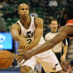 Utah Jazz small forward Richard Jefferson (24) pass the ball around the defense of Houston Rockets shooting guard James Harden (13) during a game at EnergySolutions Arena on Monday, Dec. 2, 2013.