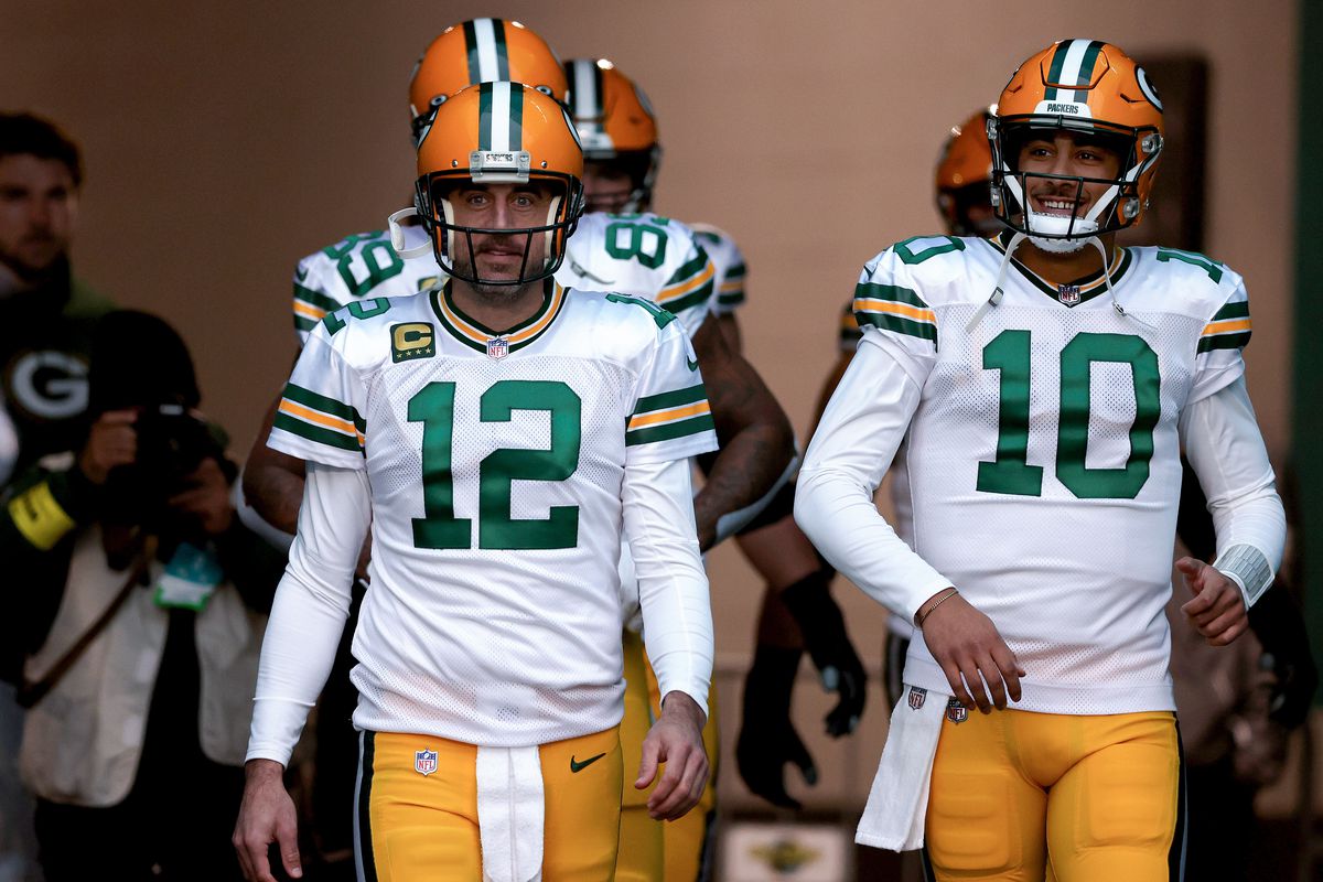 Aaron Rodgers and Jordan Love of the Green Bay Packers take the field prior to a game against the Miami Dolphins at Hard Rock Stadium on December 25, 2022 in Miami Gardens, Florida.