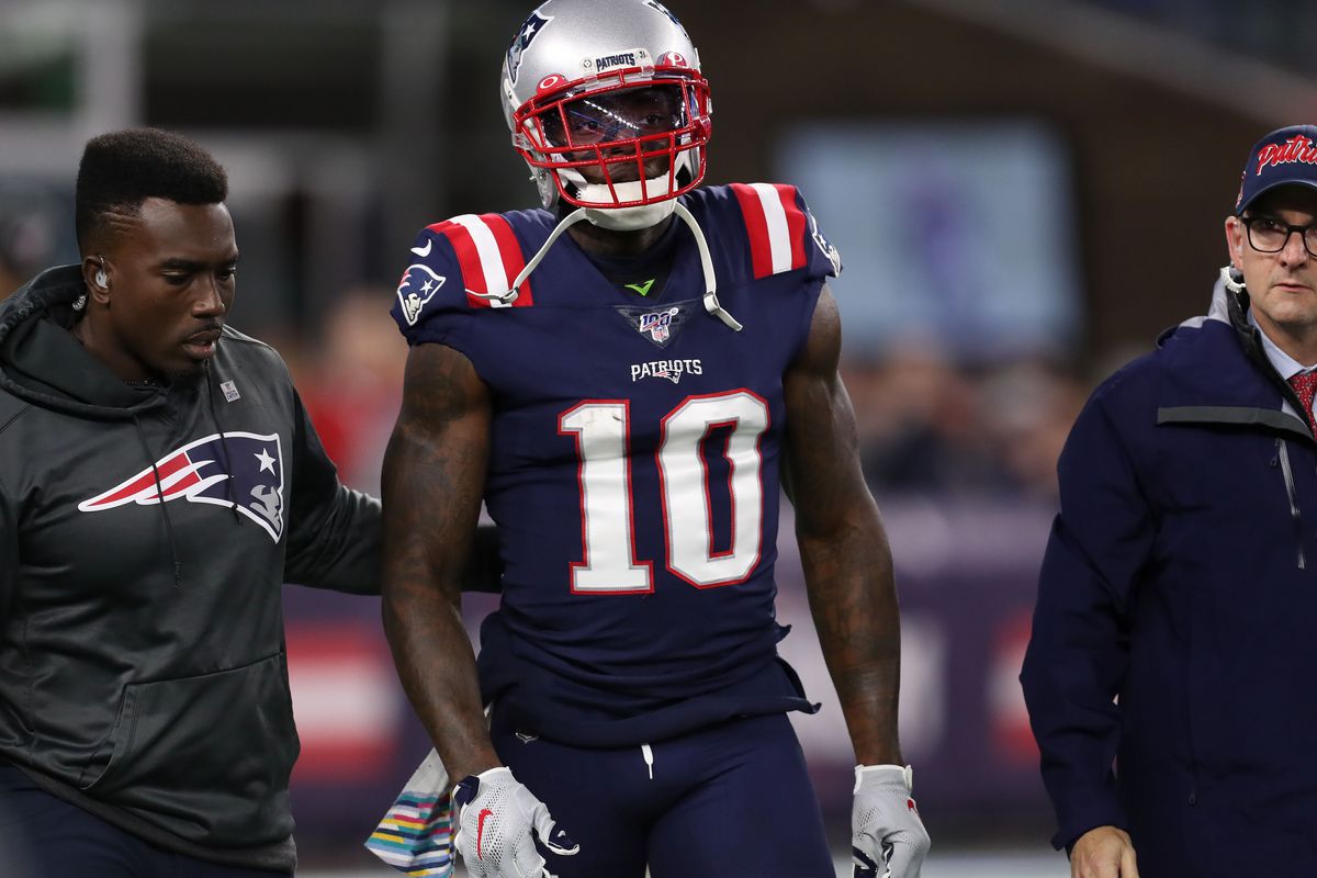 New England Patriots wide receiver Josh Gordon is helped off of the field during the first half against the New York Giants at Gillette Stadium.
