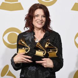 Rosanne Cash poses in the press room with the awards for best American roots performance for “A Feather's Not A Bird”, best American roots song for “A Feather's Not A Bird” and best Americana album for “The River & The Thread” at the 57th annual Grammy Awards at the Staples Center on Sunday, Feb. 8, 2015, in Los Angeles. 