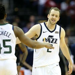 Utah Jazz guard Donovan Mitchell (45) fives teammate Utah Jazz forward Joe Ingles (2) after Ingles drained a three pointer as the Utah Jazz and the Houston Rockets play game two of the NBA playoffs at the Toyota Center in Houston on Wednesday, May 2, 2018.
