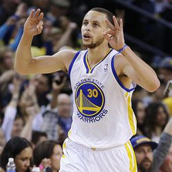 Golden State Warriors' Stephen Curry celebrates after scoring against the Utah Jazz during the first half of an NBA basketball game, Sunday, April 7, 2013, in Oakland, Calif. 