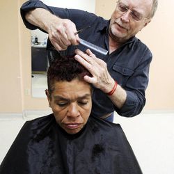 Stuart Stone cuts Maria Rojas' hair at the Weigand Homeless Day Center in Salt Lake City, Monday, April 8, 2013.