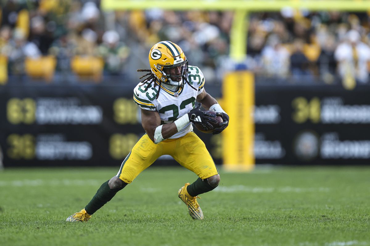 Aaron Jones #33 of the Green Bay Packers runs the ball during an NFL football game against the Pittsburgh Steelers at Acrisure Stadium on November 12, 2023 in Pittsburgh, Pennsylvania.