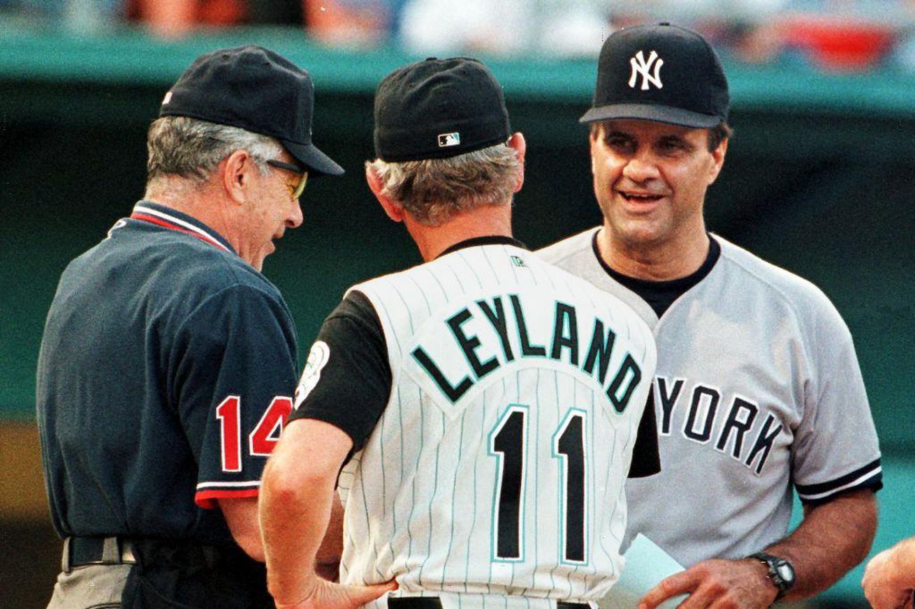 Home plate umpire Frank Pulli (L) watches New York Yankees manager Joe Torre (R) and Florida Marlins manager Jim Leyland (C) meet at the plate 13 June at Pro Player Stadium in Miami, Florida before their first-ever interleague game. Major league baseball scheduled the interleague games as an experiment to increase fan interest.
