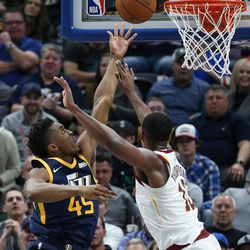 Utah Jazz guard Donovan Mitchell (45) puts the ball behind Cleveland Cavaliers center Tristan Thompson (13) at Vivint Arena in Salt Lake City on Saturday, Dec. 30, 2017.