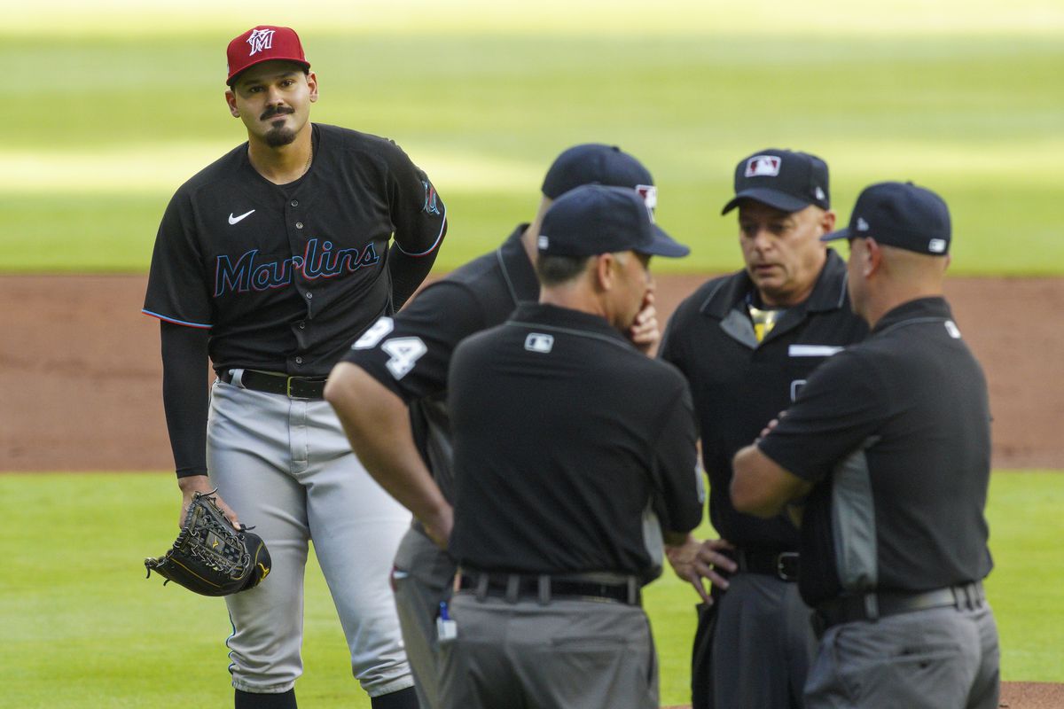Miami Marlins starting pitcher Pablo Lopez (49) looks on as umpires talk after Lopez hit Atlanta Braves right fielder Ronald Acuna Jr.