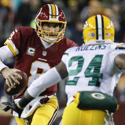 Washington Redskins quarterback Kirk Cousins (8) scrambles past Green Bay Packers cornerback Quinten Rollins (24) during the first half of an NFL football game in Landover, Md., Sunday, Nov. 20, 2016. 