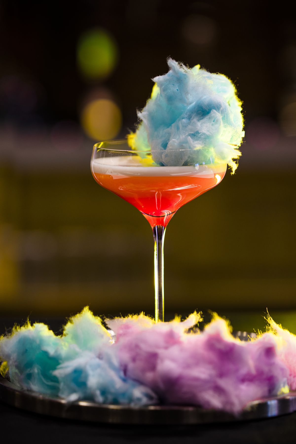 A cocktail with multicolored cotton candy.
