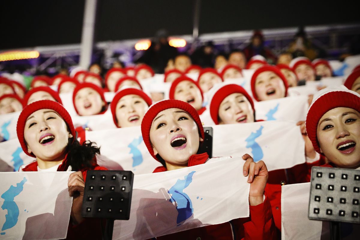 North Korean cheerleaders sing and wave prior to the Opening Ceremony.