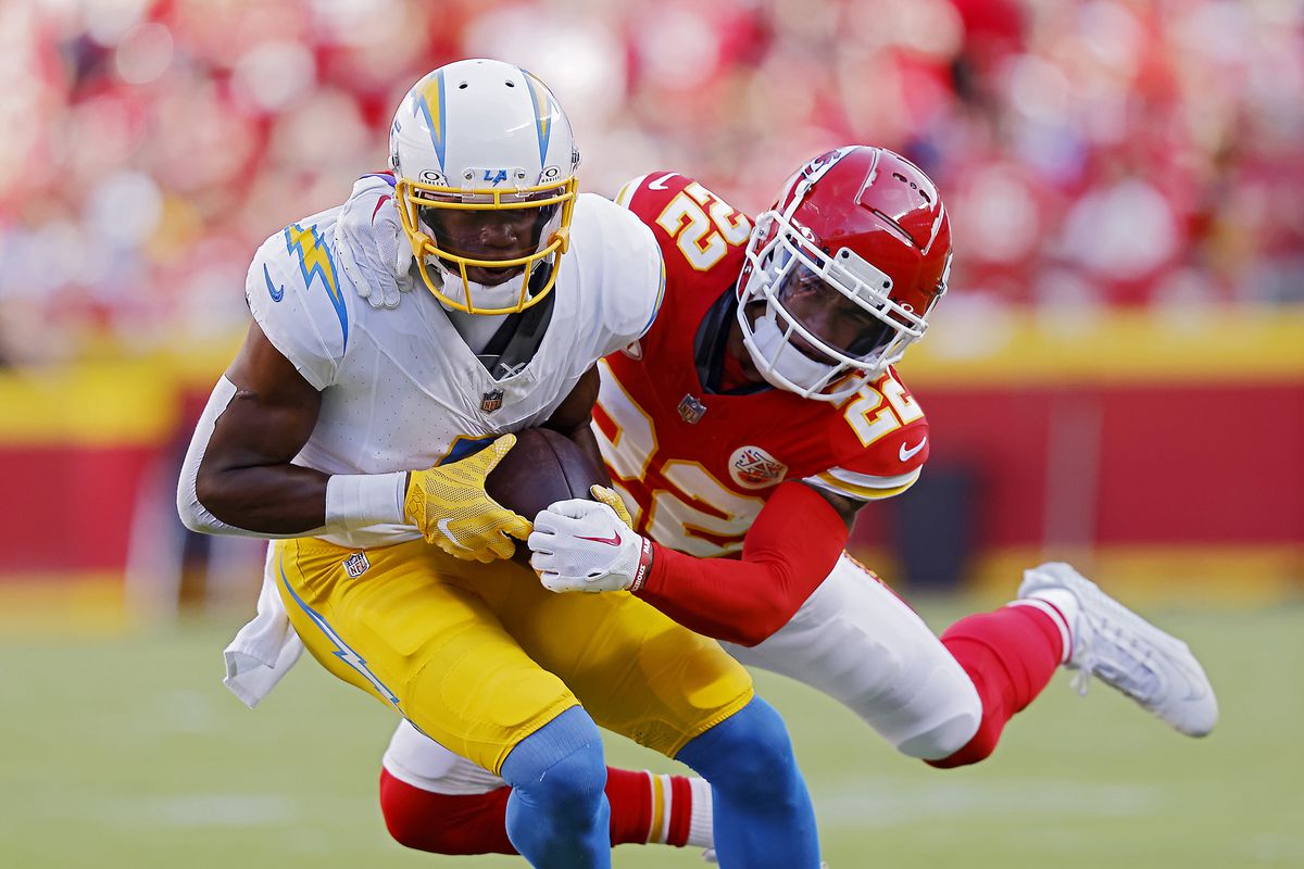 Joshua Palmer #5 of the Los Angeles Chargers is tackled by Trent McDuffie #22 of the Kansas City Chiefs during the first quarter at GEHA Field at Arrowhead Stadium on October 22, 2023 in Kansas City, Missouri.