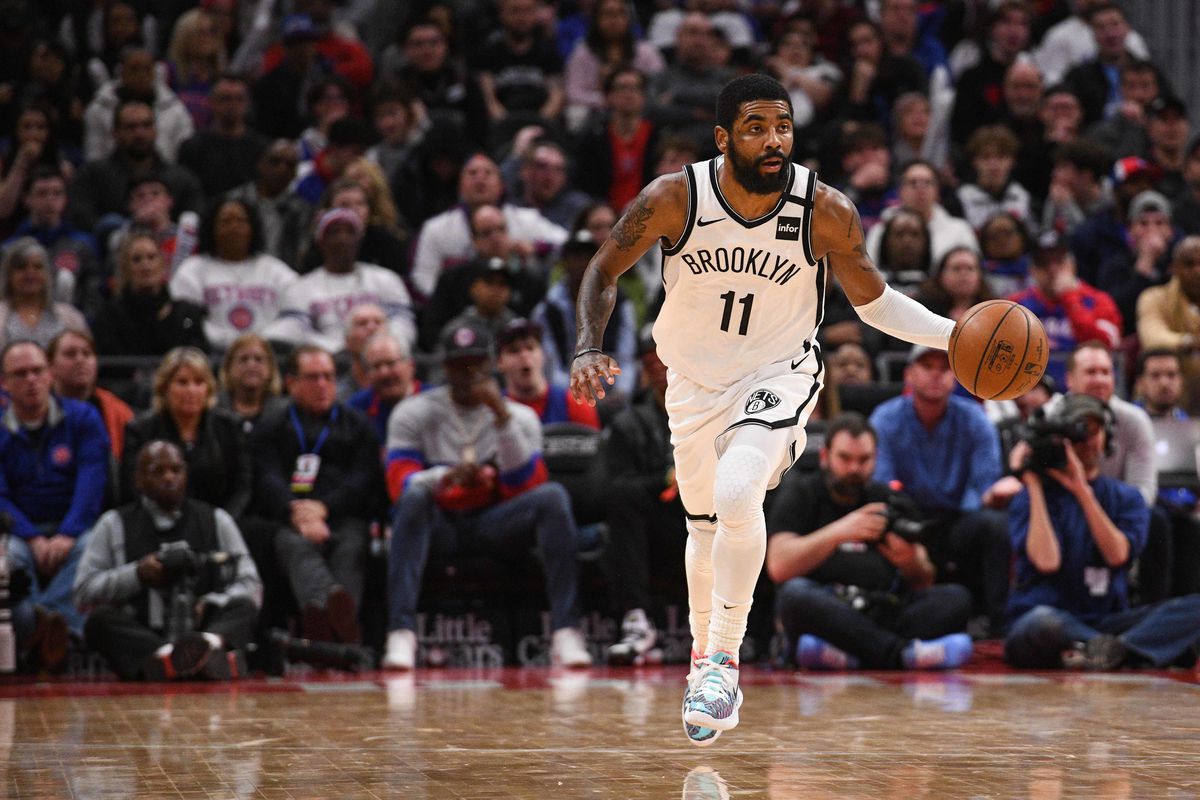 Brooklyn Nets guard Kyrie Irving brings the ball up court during the overtime Detroit Pistons at Little Caesars Arena.
