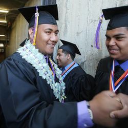 Sione Pivivi, left, has some fun as more than 500 graduate during the Horizonte Instruction and Training Center's commencement at the University of Utah in Salt Lake City on Wednesday, June 5, 2013.