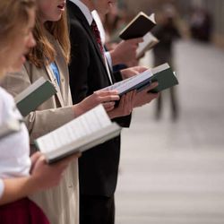 A group of members lined the sidewalks singing hymns together at the Sunday morning session of the 183rd Annual General Conference of The Church of Jesus Christ of Latter-Day Saints Sunday, April 7, 2013.