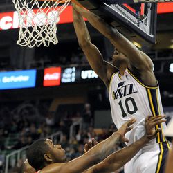 Utah Jazz point guard Alec Burks (10) is fouled by Houston Rockets power forward Terrence Jones (6) while going to the basket during a game at EnergySolutions Arena on Monday, Dec. 2, 2013.