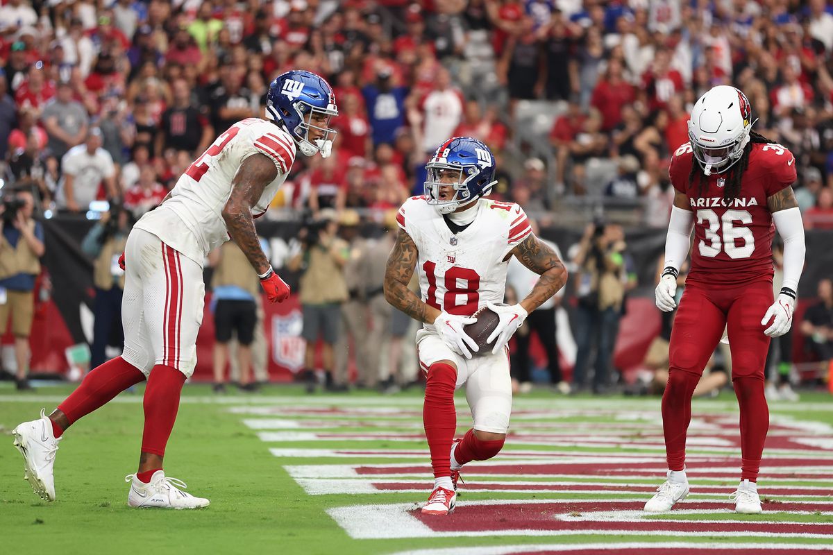 Wide receiver Isaiah Hodgins of the New York Giants catches a 11-yard touchdown reception against the Arizona Cardinals during the NFL game at State Farm Stadium on September 17, 2023 in Glendale, Arizona. The Giants defeated the Cardinals 31-28.