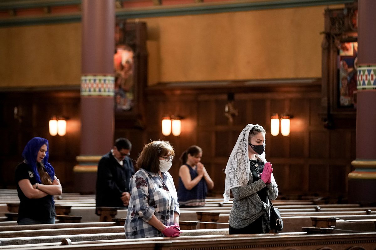 Ursula Quintana, right, and her mother, Joleen Rogers, third from left, attend Mass at the Cathedral of the Madeleine on Tuesday, May 12, 2020.