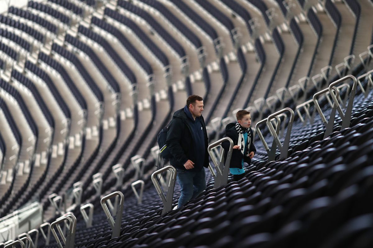Tottenham Hotspur fans head for their seats in the giant...