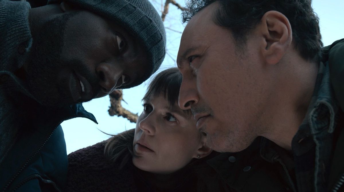David (Mike Colter), Kristen (Katja Herbers), and Ben (Aasif Mandvi) huddle together whispering in Paramount Plus’ Evil