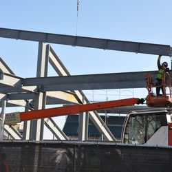 Steel girder being lowered into position in the left-field bleachers - 