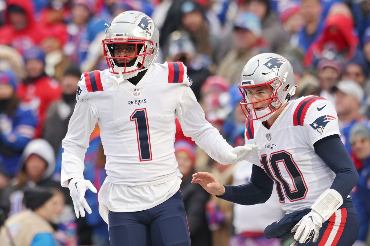 DeVante Parker #1 of the New England Patriots and Mac Jones #10 of the New England Patriots celebrate after Parker’s touchdown reception during the fourth quarter against the Buffalo Bills at Highmark Stadium on January 08, 2023 in Orchard Park, New York.