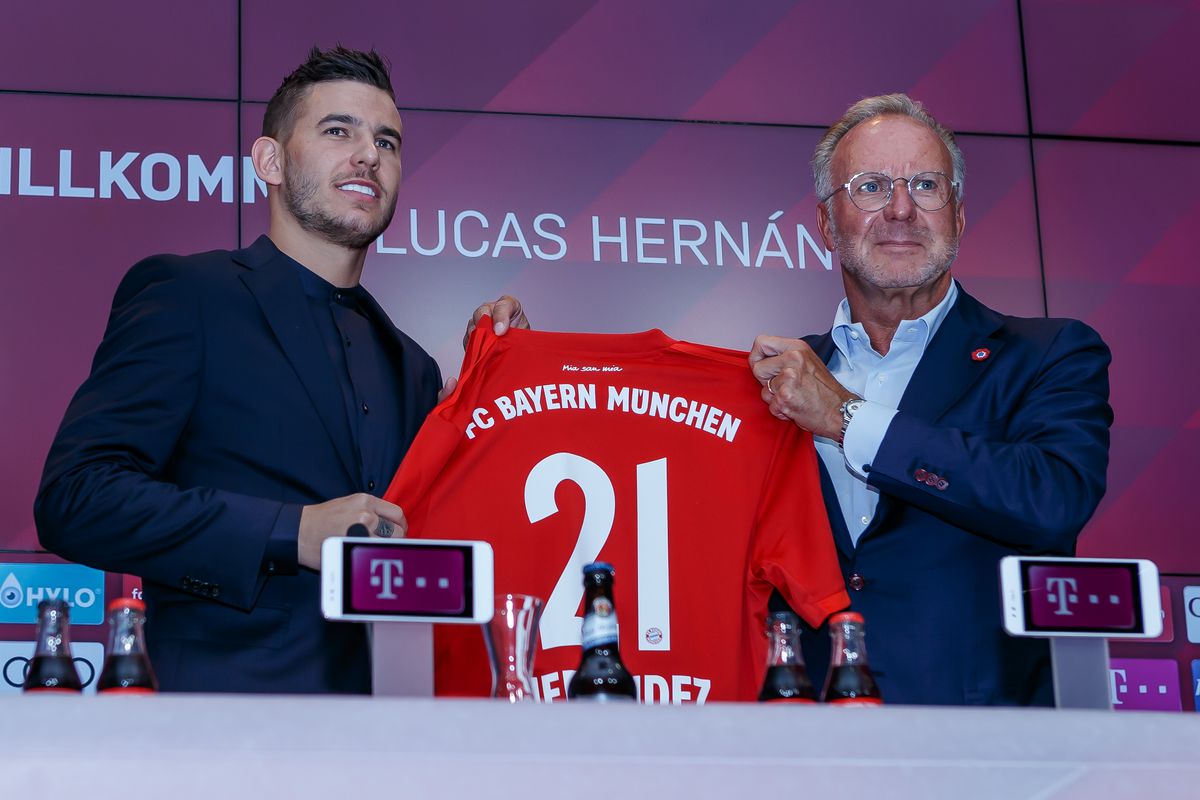 FC Bayern Muenchen Unveils New Signing Lucas Hernandez
SEGOVIA, SPAIN - JULY 08: Lucas Hernandez of FC Bayern Muenchen and Karl-Heinz Rummenigge of FC Bayern Muenchen present the Trickot with the number 21 during a press conference to announce new signing Lucas Hernandez at Allianz Arena on July 8, 2019 in Munich, Germany.