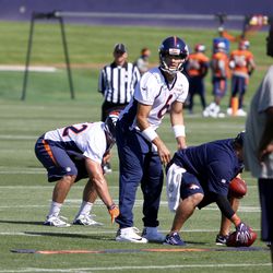 Broncos QB Mark Sanchez looks over the field before the snap during drills.