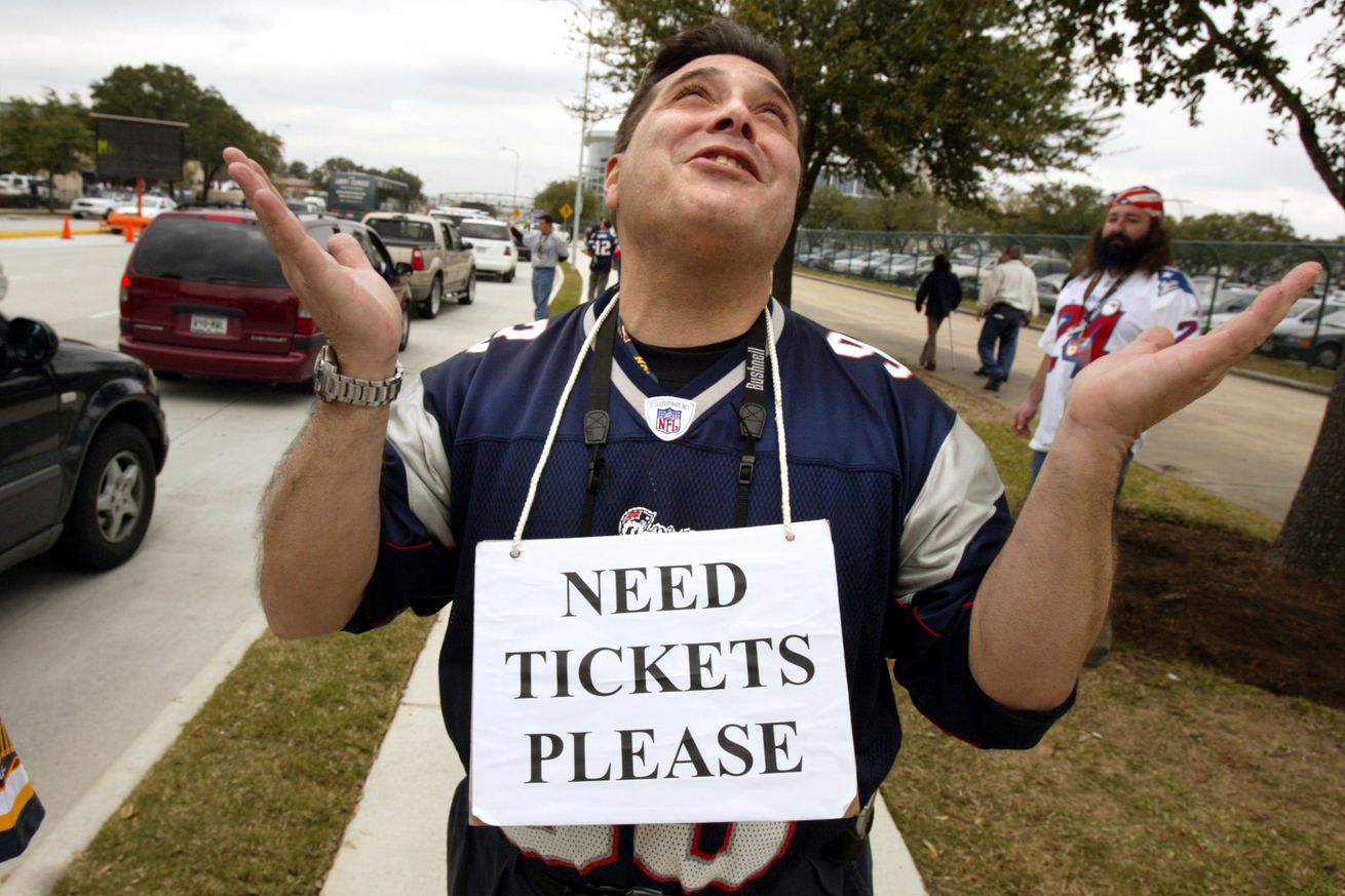 (2/1/04 Houston, TX) OH PLEASE, GOD, PLEASE.... Jim Totovian of Watertown prays to God for a ticket as he wanders along Kirby Drive outside Superbowl XXXVIII: New England Patriots vs. Carolina Panthers at the Reliant Dome in Houston. (A50G0073.JP