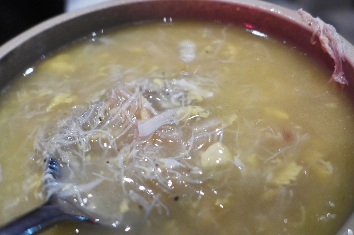 A soup of pale shreds in a gray broth.