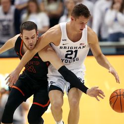 Pacific Tigers guard Luke Avdalovic (21) knocks the ball away from Brigham Young Cougars guard Trevin Knell (21) near midcourt as BYU and Pacific play in an NCAA basketball game in Provo at the Marriott Center on Thursday, Jan. 6, 2022.