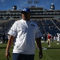 Brigham Young Cougars head coach Kalani Sitake stands on the sideline as teams warm up before a game against the UMass Minutemen at LaVell Edwards Stadium in Provo on Saturday, Nov. 19, 2016.