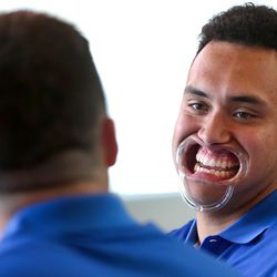 BYU tight end Moroni Laulu-Pututau plays the game Speak Out with teammate BYU quarterback Tanner Mangum during a video interview at the BYU football media day in the BYU Broadcasting Building on the BYU campus in Provo on Friday, June 22, 2018. Part of the game is to put a plastic peace in your mouth that holds your lips back and read a phrase and get your partner to guess what you are saying.