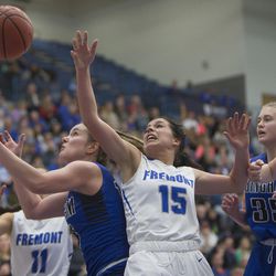 Bingham's Maggie Mccord and Fremont's Mazzie Melaney grab for the ball during Fremont's 61-47 victory against Bingham in the Class 6A state championship game at Salt Lake Community College in Taylorsville on Saturday, Feb. 24, 2018.